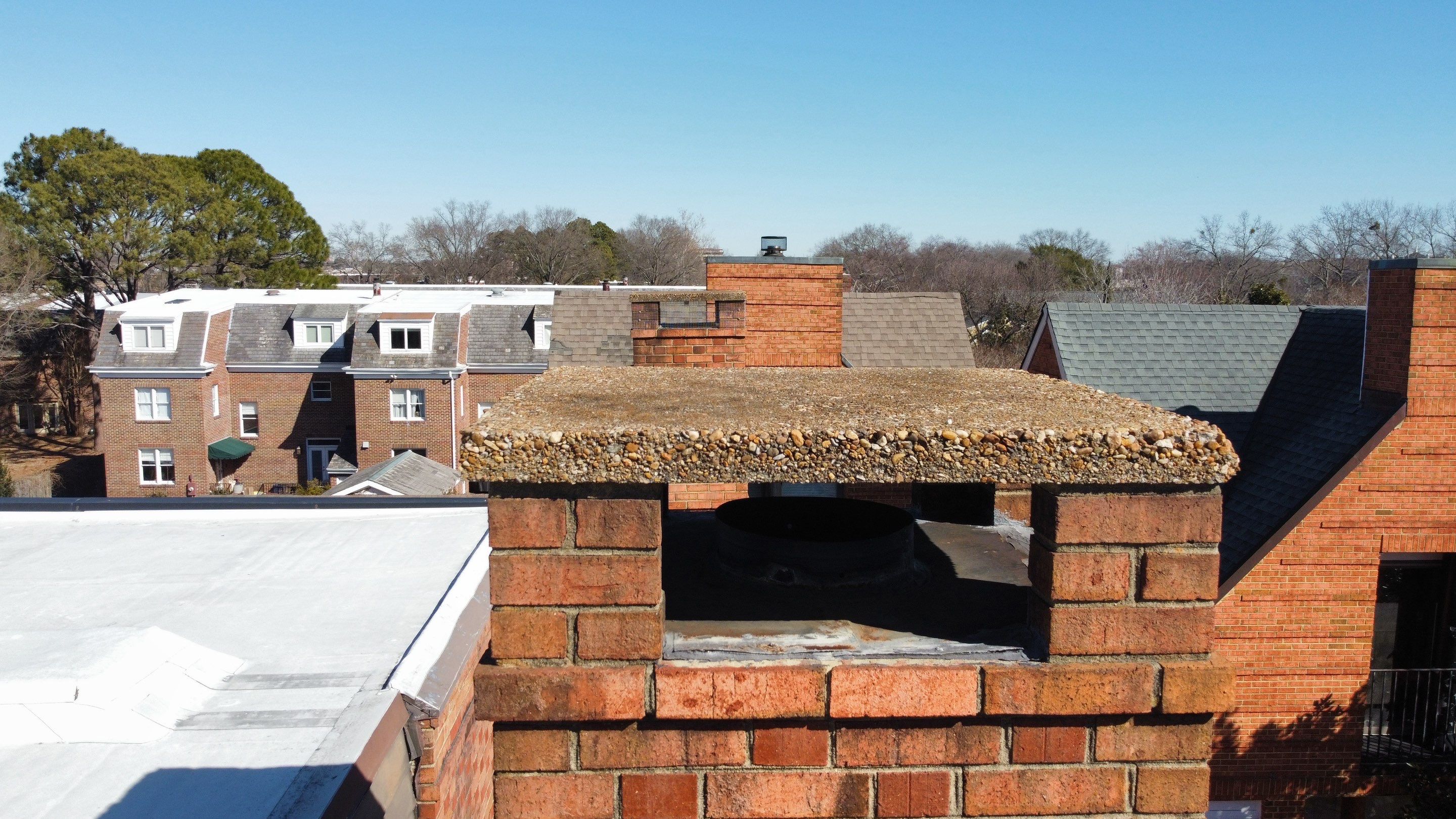 During a recent chimney inspection in Norfolk, VA, we recommended installing proper screens on all four sides of the concrete cap.